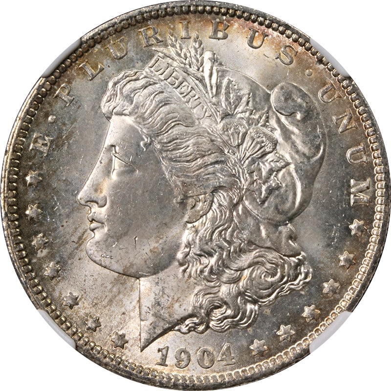 1904-O NGC MS65 Morgan Silver Dollar with Beautiful Toning: 1904-O NGC MS65 Morgan Silver Dollar with Beautiful Toning This stunning 1904-O Morgan Silver Dollar, certified by NGC with a grade of MS65, showcases exceptional quality and beautiful toning. Struck 