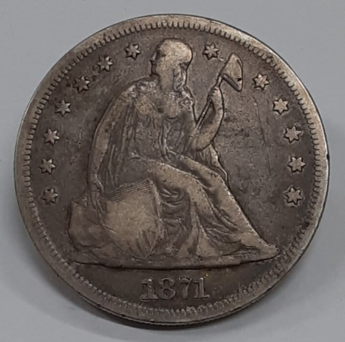 Seated Liberty 1871 Silver Dollar Coin Philadelphia Circulated with Rim Dings: Seated Liberty 1871 Silver Dollar Coin Philadelphia Circulated with Rim Dings This is an 1871 Seated Liberty Silver Dollar from the United States, featuring a silver composition with a fineness of 0.9