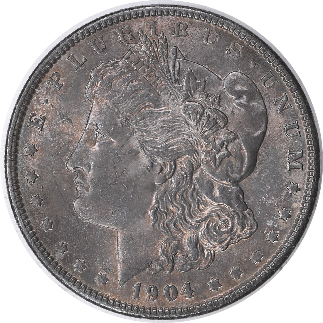 1904 Silver Morgan Dollar Choice BU Toned Uncertified US Coin: 1904 Silver Morgan Dollar Choice BU Toned Uncertified US Coin This 1904 Morgan Silver Dollar is a Choice Brilliant Uncirculated coin with attractive toning. It is uncertified, has no mint mark, and is