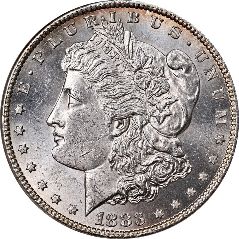 1883-CC Morgan Silver Dollar ANACS MS62 Uncirculated Silver Coin: 1883-CC Morgan Silver Dollar ANACS MS62 Uncirculated Silver Coin This original 1883-CC Morgan Silver Dollar, certified by ANACS with a grade of MS62, showcases remarkable eye appeal with a brilliant l