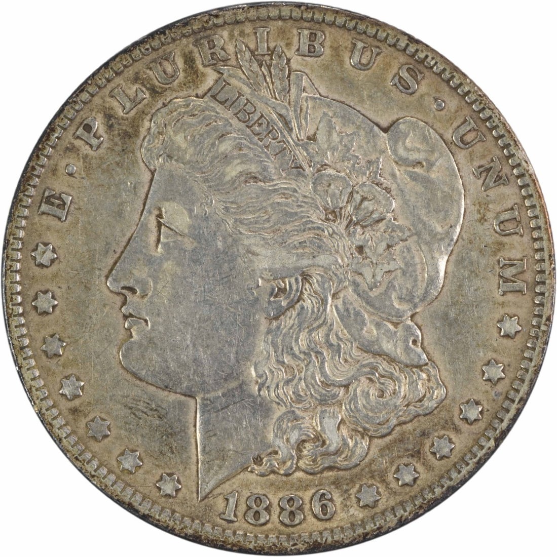 1886-O Morgan Silver Dollar XF Uncertified New Orleans 90% Silver: 1886-O Morgan Silver Dollar XF Uncertified New Orleans 90% Silver This 1886-O Morgan Silver Dollar is a classic piece of American numismatics, showcasing the artistry of designer George T. Morgan. The