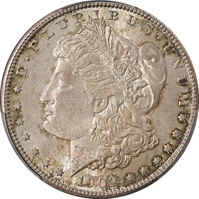 PCGS MS63 1902-O Morgan Silver Dollar with Toning: PCGS MS63 1902-O Morgan Silver Dollar with Toning This 1902-O Morgan Silver Dollar is graded MS63 by PCGS and features attractive toning. Struck at the New Orleans Mint, this uncirculated coin is comp