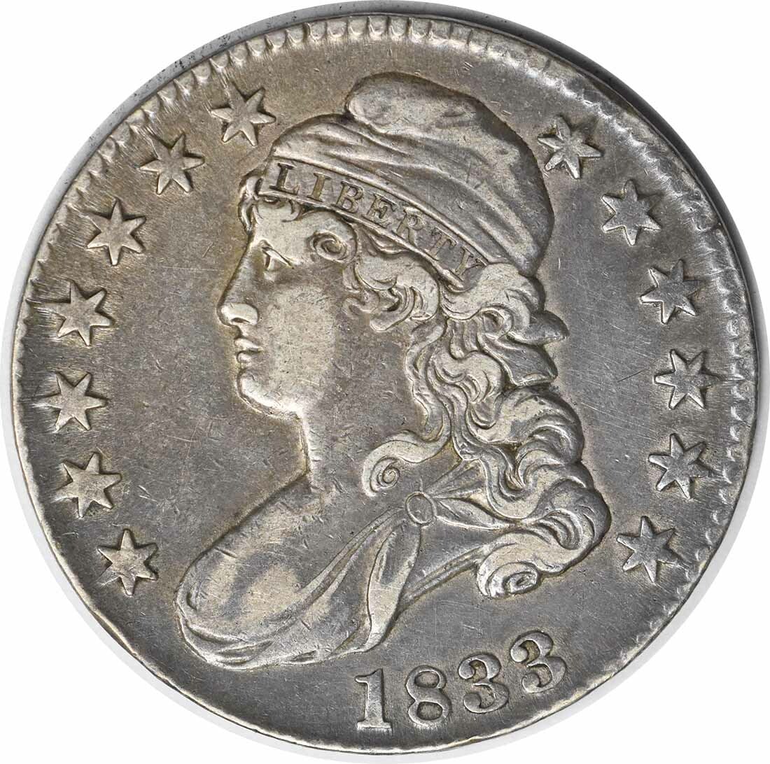 1833 Bust Half Dollar 50C by John Reich Circulated Silver Coin: 1833 Bust Half Dollar 50C by John Reich Circulated Silver Coin This 1833 Bust Half Dollar is a remarkable piece of American numismatic history. Crafted in Philadelphia, this coin features a beautiful 