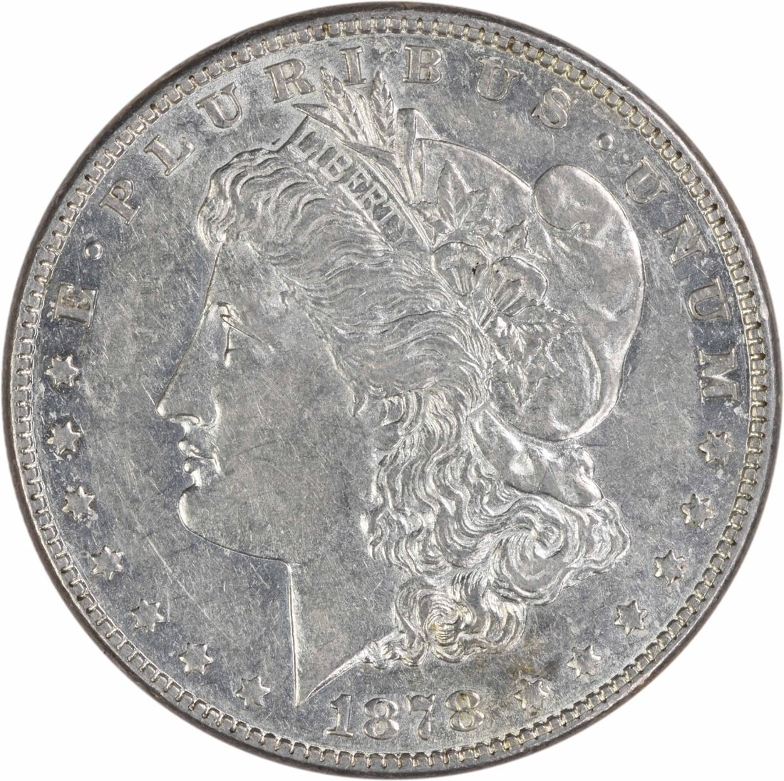 1878 Morgan Dollar 7 over 8 Tail Feathers EF Uncertified Silver Coin: 1878 Morgan Dollar 7 over 8 Tail Feathers EF Uncertified Silver Coin This 1878 Morgan Silver Dollar features the 7/8 Tail Feathers variety and was minted in Philadelphia. Designed by George T. Morgan,