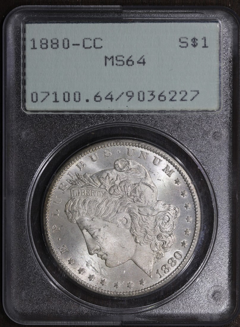 PCGS MS64 Carson City 1880 Morgan Silver Dollar in Rattler Holder: PCGS MS64 Carson City 1880 Morgan Silver Dollar in Rattler Holder This is an un-used 1880-CC Morgan Silver Dollar graded MS64 by PCGS. Minted in Carson City, this $1 coin is composed of 90% silver and