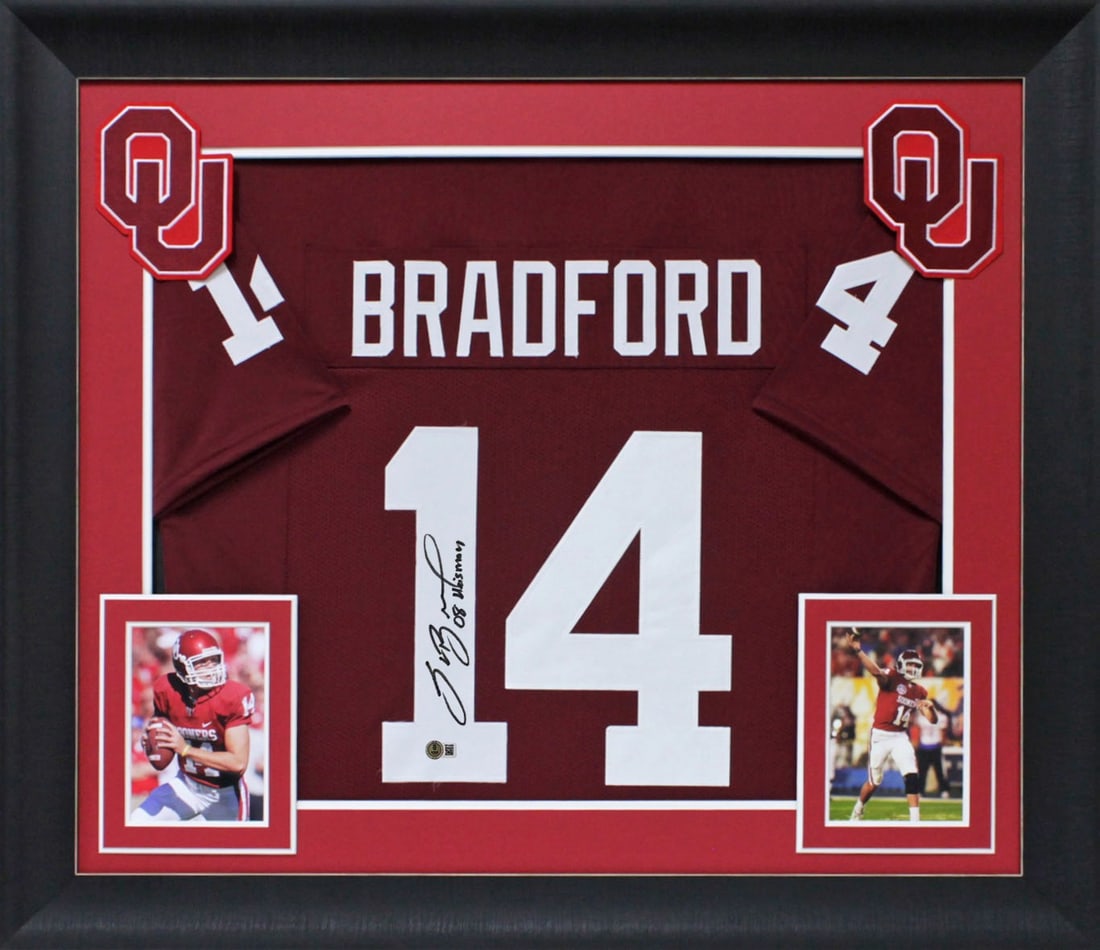Framed Oklahoma Sam Bradford Signed Jersey With 2008 Heisman Inscription BAS Authenticated: Framed Oklahoma Sam Bradford Signed Jersey With 2008 Heisman Inscription BAS Authenticated This professionally framed maroon Pro Style jersey is personally signed by Sam Bradford of the Oklahoma Soone