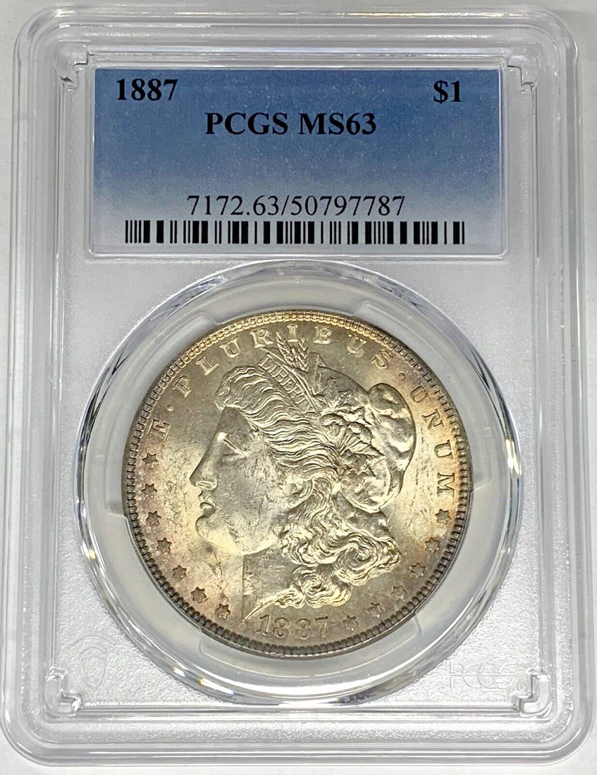 PCGS MS 63 1887 Silver Morgan Dollar Coin With Toning: PCGS MS 63 1887 Silver Morgan Dollar Coin With Toning This 1887 Morgan Silver Dollar is an uncirculated coin graded MS 63 by PCGS. It features natural toning and is composed of silver. The coin was mi