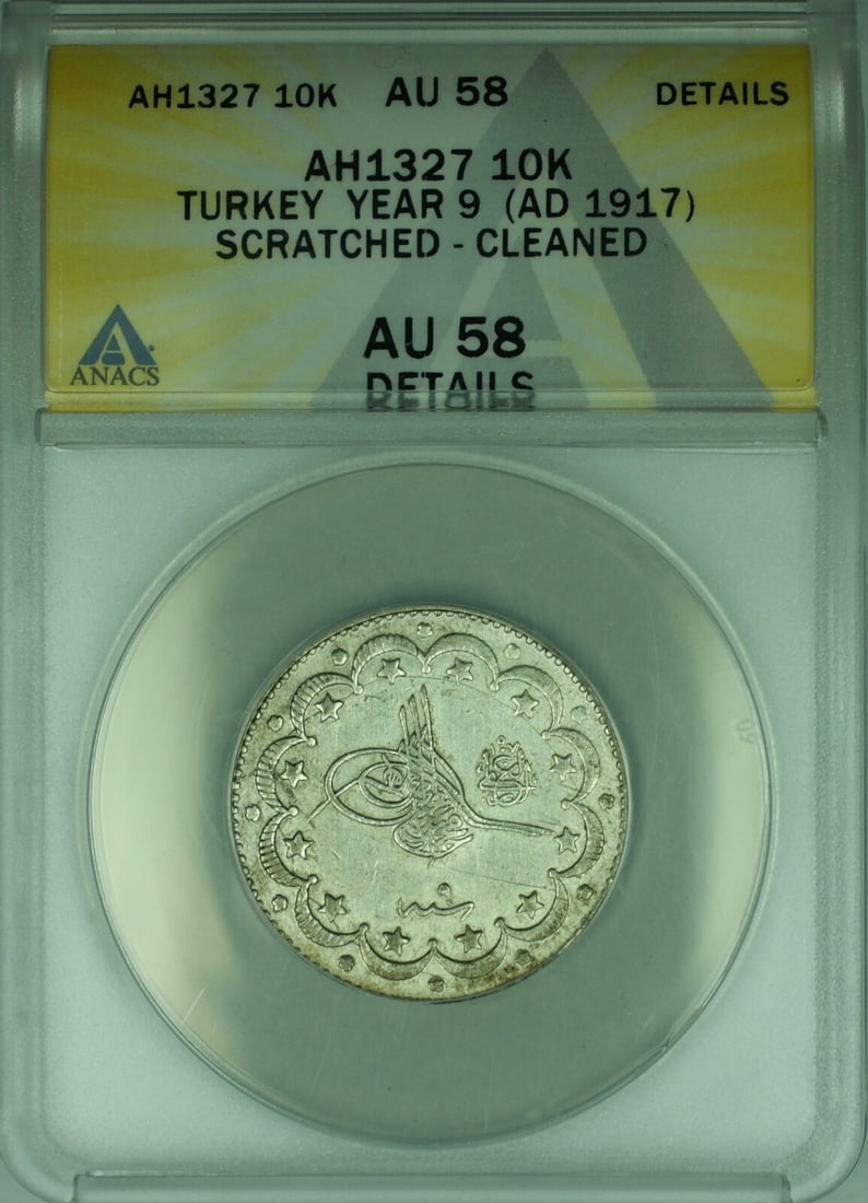 ANACS AU 58 Turkey 1917 Silver 10 Kurus Coin KM 772 Scratched Cleaned: ANACS AU 58 Turkey 1917 Silver 10 Kurus Coin KM 772 Scratched Cleaned This 1917 Turkish 10 Kurus coin, struck in silver with a fineness of 0.83, is certified by ANACS and graded AU 58 Details. The coi