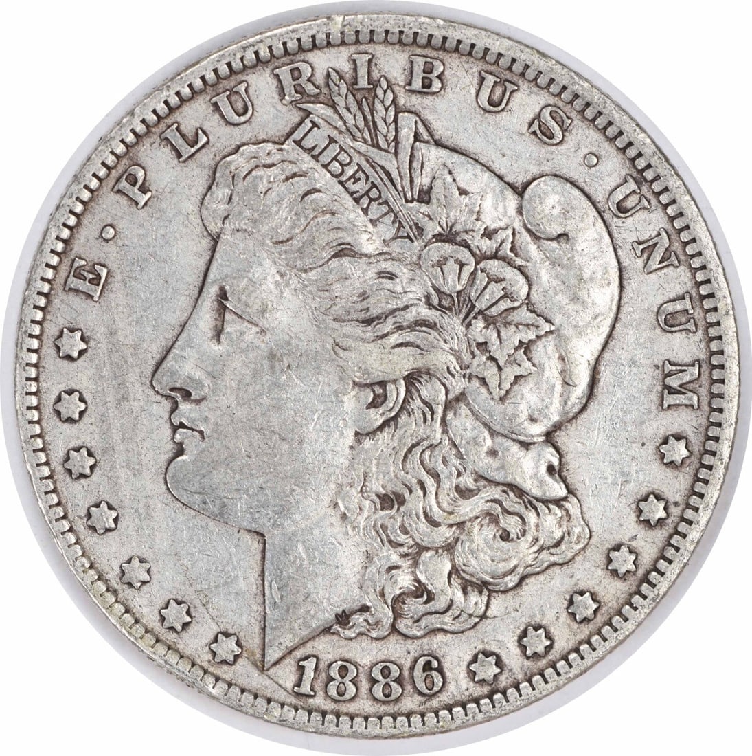 1886-O Morgan Silver Dollar XF Uncertified New Orleans Coin: 1886-O Morgan Silver Dollar XF Uncertified New Orleans Coin This 1886-O Morgan Silver Dollar is a remarkable piece from the New Orleans Mint, featuring a classic design by George T. Morgan. The coin i