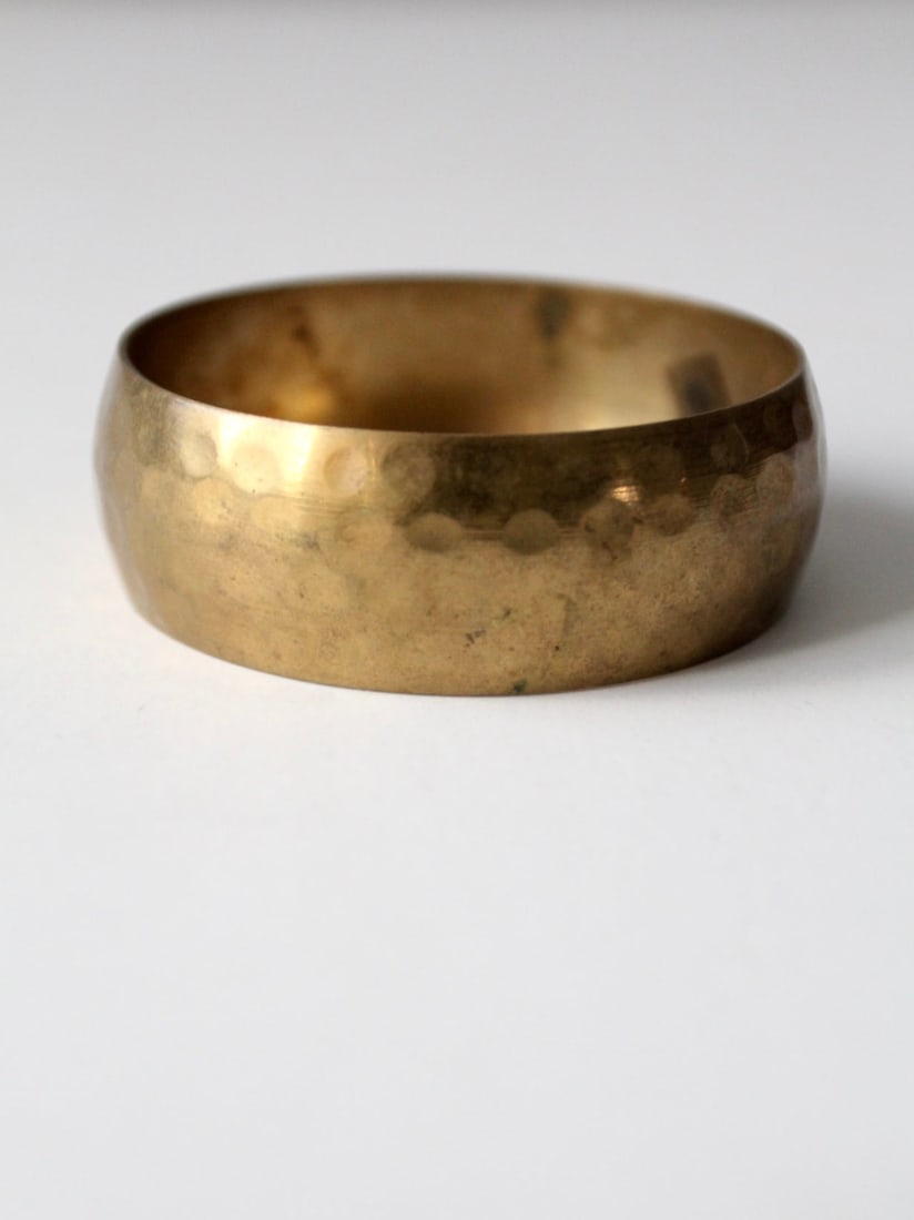 Vintage Hammered Brass Bangle with Unique Patina: Vintage Hammered Brass Bangle with Unique Patina This vintage hammered brass bangle is perfect for stacking with other bracelets or wearing solo. It features a striking patina that adds character and 