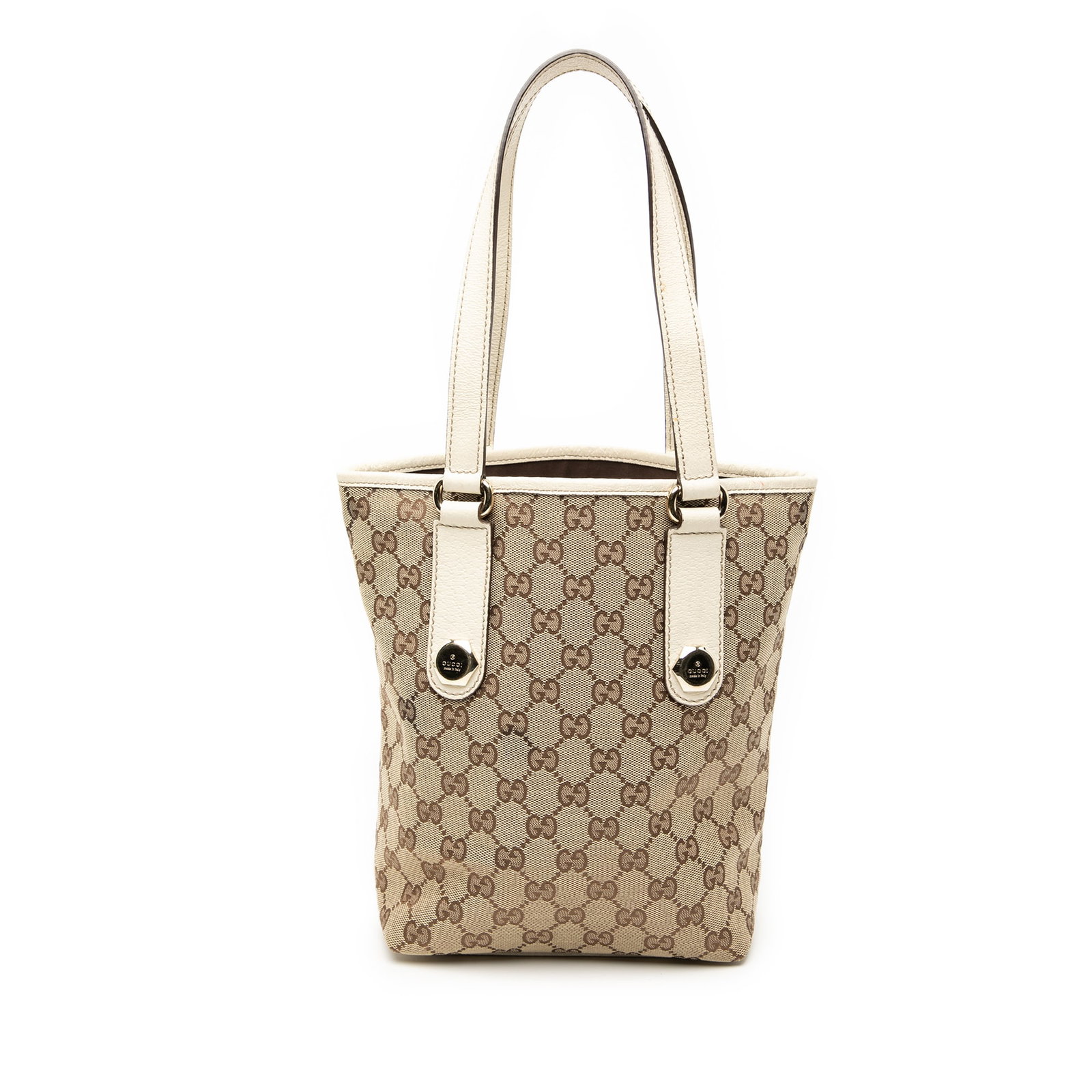 Brown GG Canvas Charmy Tote Bag by Gucci with Leather Trim: Brown GG Canvas Charmy Tote Bag by Gucci with Leather Trim The Gucci GG Canvas Charmy Tote features a brown canvas body with leather trim and flat leather shoulder straps. It has an open top design an