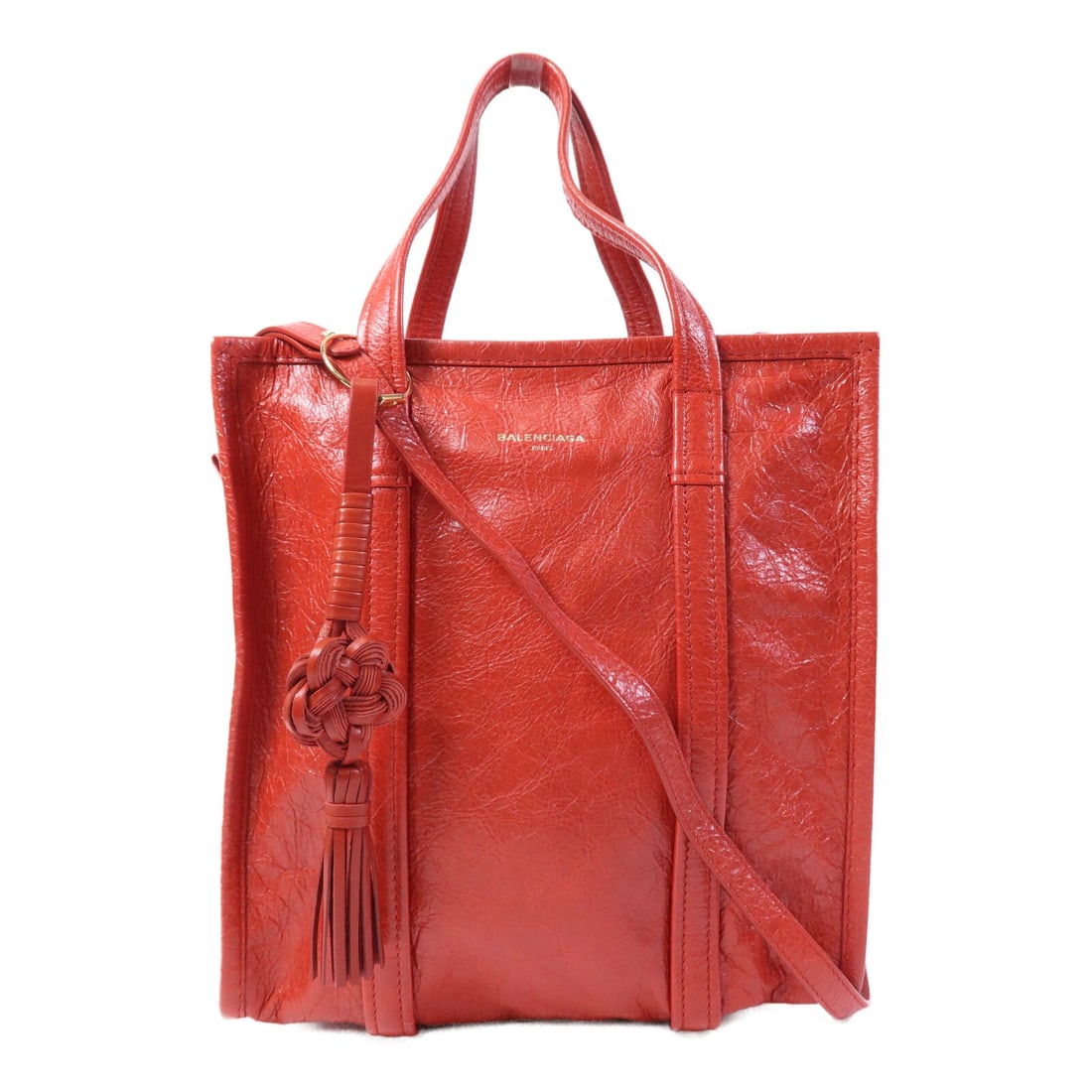 Balenciaga Bazar Red Calfskin 2 Way Shoulder Bag with Gold Hardware: Balenciaga Bazar Red Calfskin 2 Way Shoulder Bag with Gold Hardware This Balenciaga Bazar 2 Way shoulder bag features a striking red calfskin leather exterior and gold tone hardware. Designed for vers