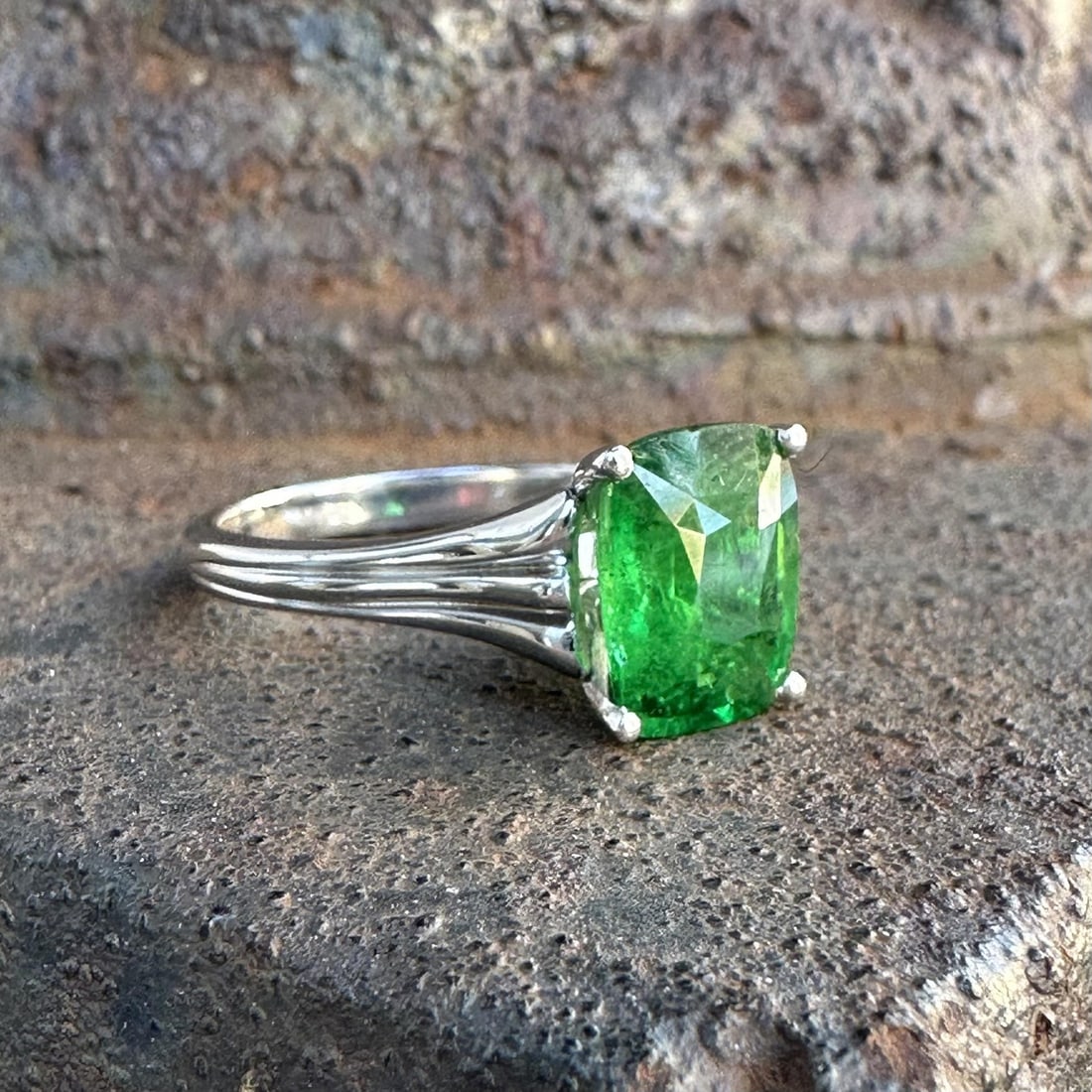 GIA Certified Platinum Ring with 3.61ct Cushion Tsavorite Garnet: GIA Certified Platinum Ring with 3.61ct Cushion Tsavorite Garnet This platinum solitaire ring features a vivid green, natural tsavorite cushion-cut gemstone weighing 3.61 carats, certified by GIA. The