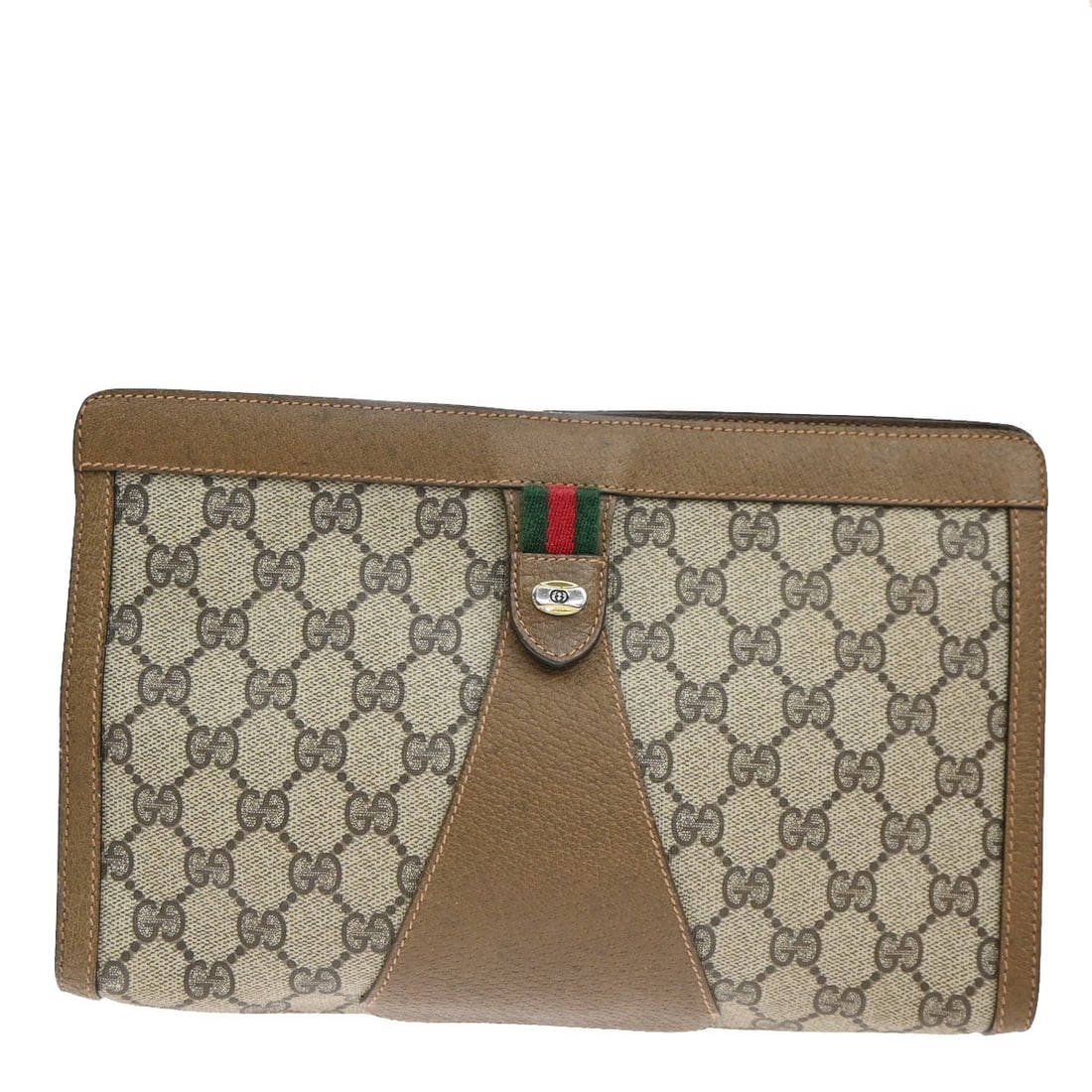 Brown Canvas Toiletry Bag Vintage GG Pattern by Gucci: Brown Canvas Toiletry Bag Vintage GG Pattern by Gucci This Gucci Vintage Toiletry Pouch features the signature GG canvas in brown, designed for unisex use. The pouch shows exterior scuffs and dirt, wi
