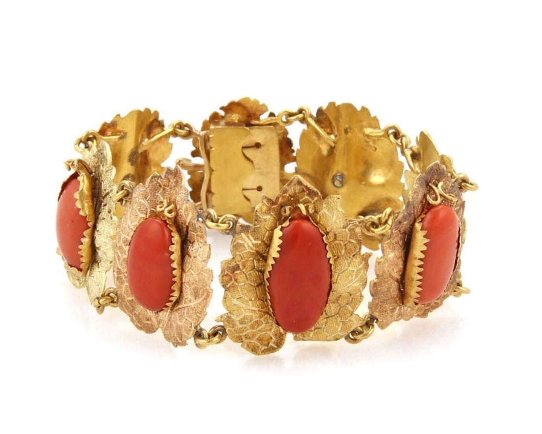 Vintage 18k Two Tone Gold Coral Leaf Link Bracelet: Vintage 18k Two Tone Gold Coral Leaf Link Bracelet This vintage link bracelet showcases a distinctive design featuring textured leaf motifs and a cabochon coral accent. Crafted from 18k two-tone gold,