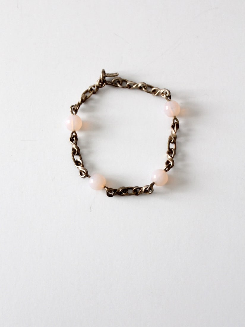 Vintage Sterling Silver Bracelet with Pale Pink Beads Hook Closure: Vintage Sterling Silver Bracelet with Pale Pink Beads Hook Closure This vintage sterling silver chain link bracelet features a delicate design adorned with pale pink beads, creating an elegant look su