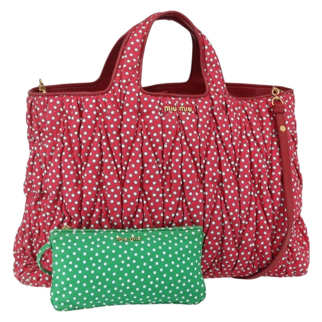 Red Canvas Matelasse Shopper Tote by Miu Miu: Red Canvas Matelasse Shopper Tote by Miu Miu This pre-owned Miu Miu Matelasse Shopper Tote is crafted from red canvas and designed for women. Made in Italy, it features a spacious silhouette with stur