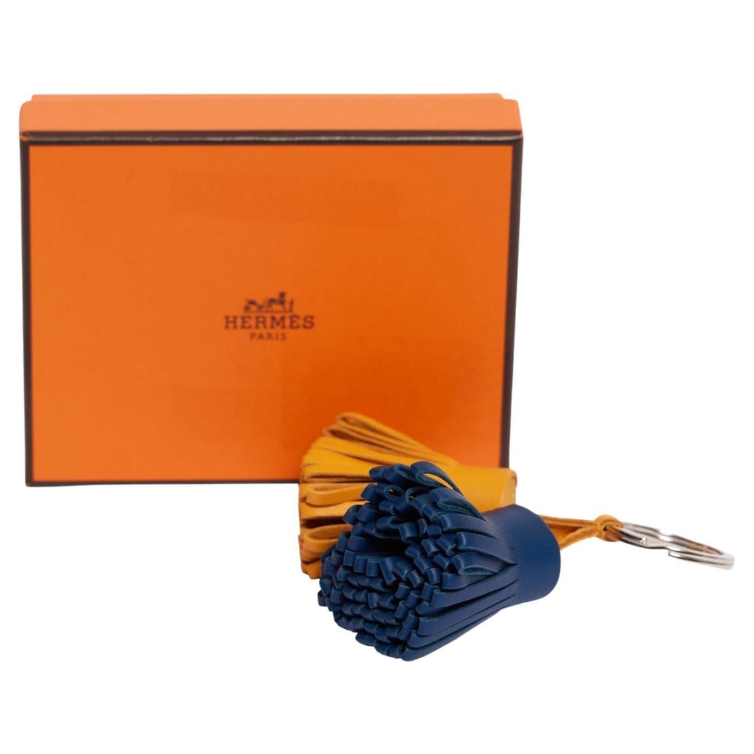 Hermes Double Carmen Bag Charm Leather Tassel Keychain: Hermes Double Carmen Bag Charm Leather Tassel Keychain Elevate your accessory collection with this exquisite Hermes Double Carmen Bag Charm. Crafted from premium curry and deep blue leather, this uniq