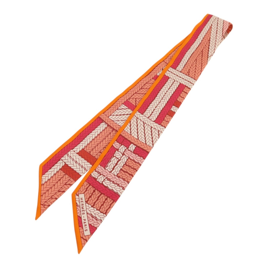 Hermes Twilly Silk Scarf for Women in Orange and Red: Hermes Twilly Silk Scarf for Women in Orange and Red This Hermes Twilly scarf is crafted from silk and features a vibrant orange, red, and multicolor design. Made in France, it is designed for women a