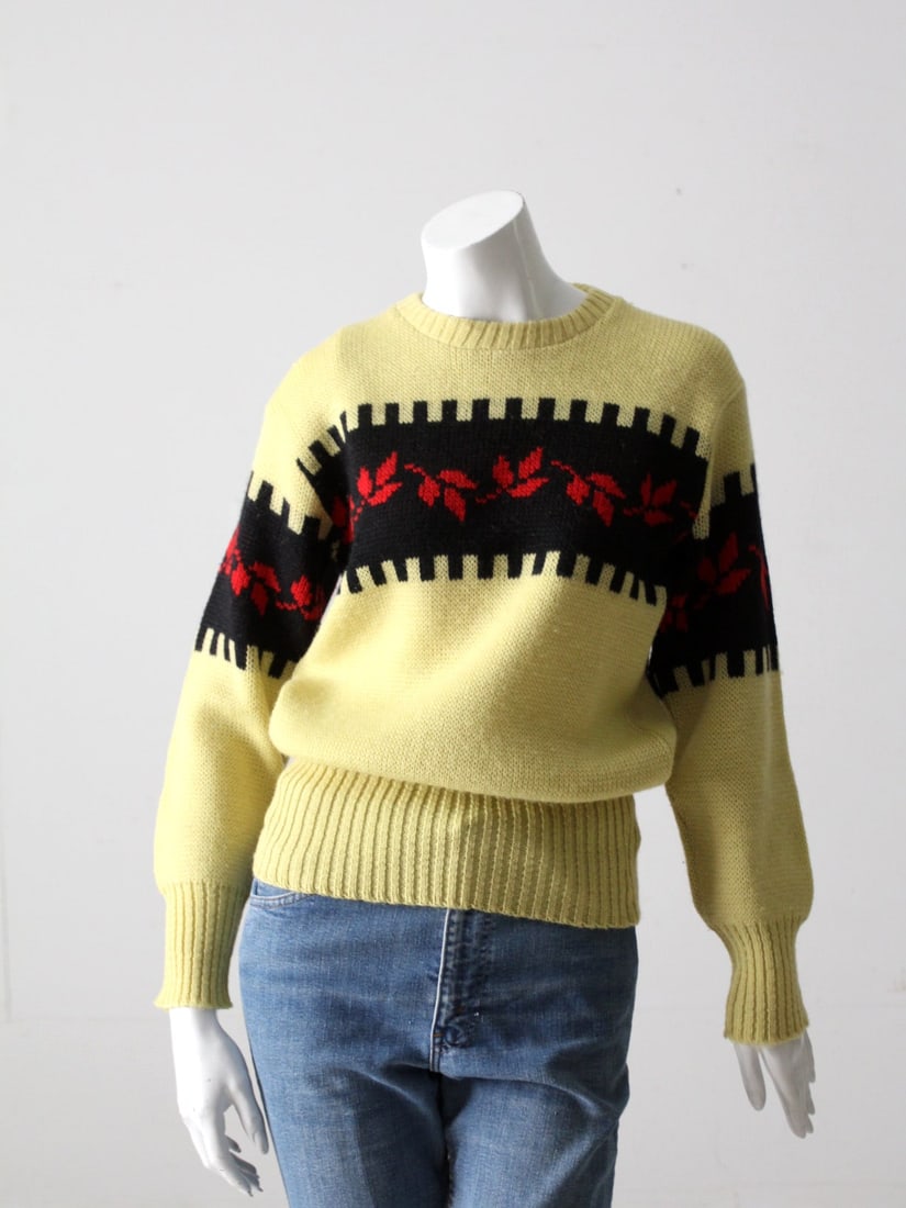 Vintage 1950s The Kandahar Wool Sweater Cream with Leaf Pattern: Vintage 1950s The Kandahar Wool Sweater Cream with Leaf Pattern This vintage 1950s sweater by The Kandahar is a stylish cream pullover adorned with a striking black and red leaf pattern across both th