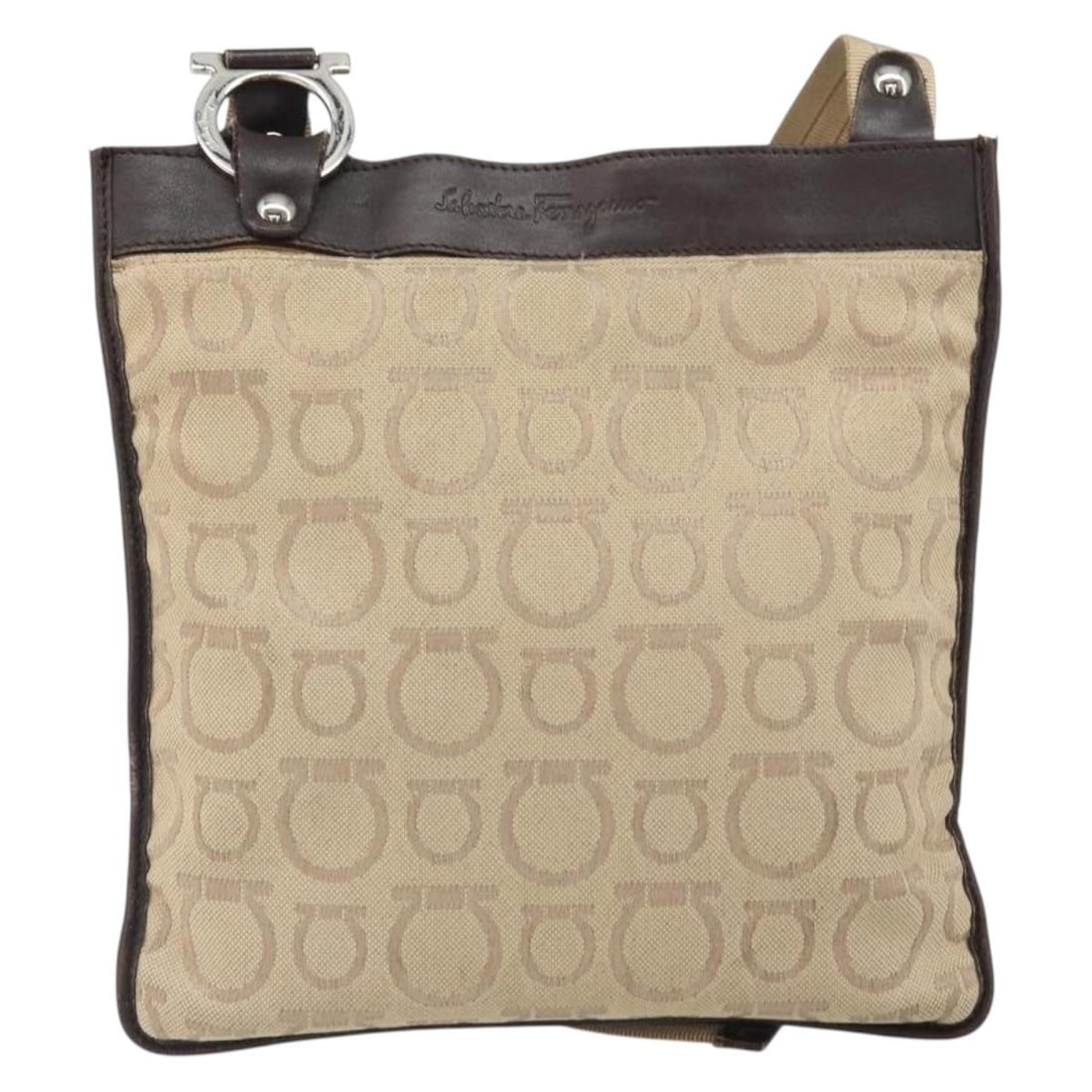 Gancini Beige Canvas Shoulder Bag by Salvatore Ferragamo: Gancini Beige Canvas Shoulder Bag by Salvatore Ferragamo This Salvatore Ferragamo Gancini Shoulder Bag features a beige canvas exterior with signature detailing. Designed for women, the bag showcases 