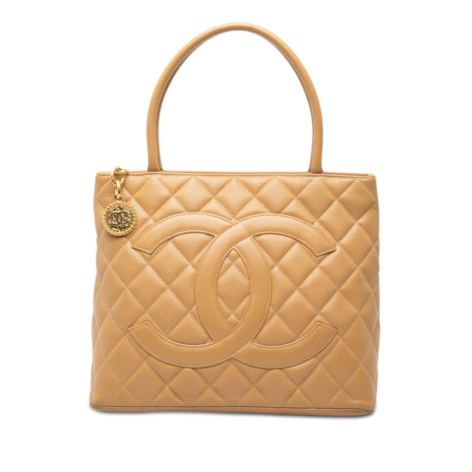 Beige Quilted Leather Medallion Tote Bag by Chanel: Beige Quilted Leather Medallion Tote Bag by Chanel This Chanel Caviar Medallion Tote features a quilted caviar leather body in beige, rolled leather handles, a top zip closure, an exterior back slip p