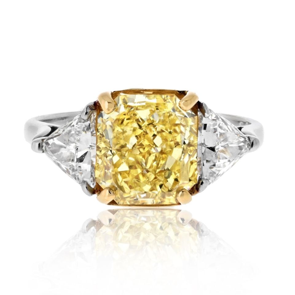 Radiant Cut 3.04ct Fancy Intense Yellow Diamond Ring with Trilliant Sides GIA: Radiant Cut 3.04ct Fancy Intense Yellow Diamond Ring with Trilliant Sides GIA This stunning Fancy Yellow Ring features a dazzling 3.04 ct GIA certified Fancy Yellow Intense Radiant Cut diamond at its 