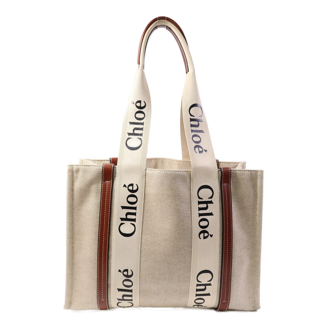 Chloe Beige Canvas Medium Tote Bag: Chloe Beige Canvas Medium Tote Bag This Chloe Woody Medium Tote Bag features a beige canvas exterior with brown accents, offering a stylish and practical design. The bag is sized for everyday use and 
