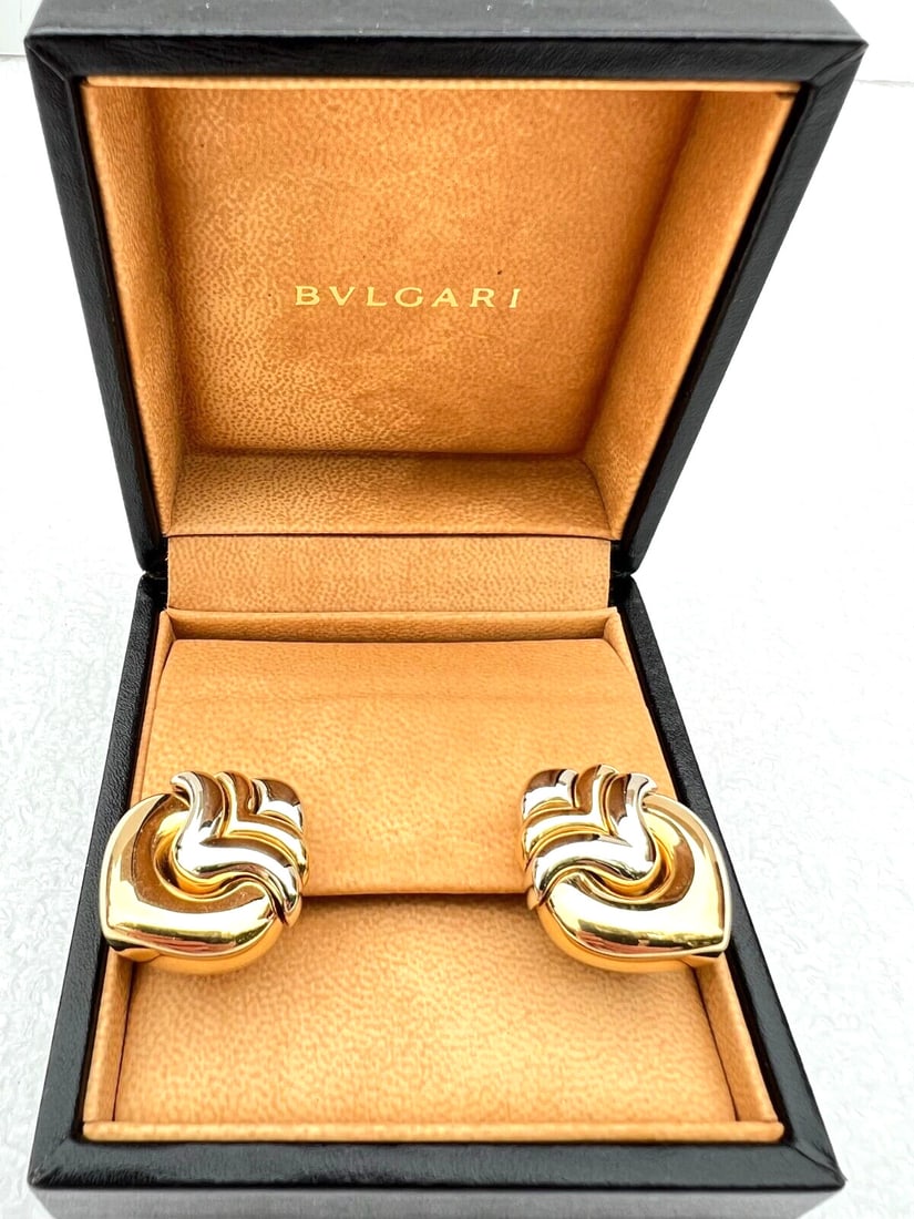 Bvlgari 18K Yellow & White Gold Cuff Earrings with Box 34g: Bvlgari 18K Yellow & White Gold Cuff Earrings with Box 34g This exquisite pair of Bvlgari earrings showcases a stunning combination of 18K yellow and white gold. Designed in a cuff style, each earring