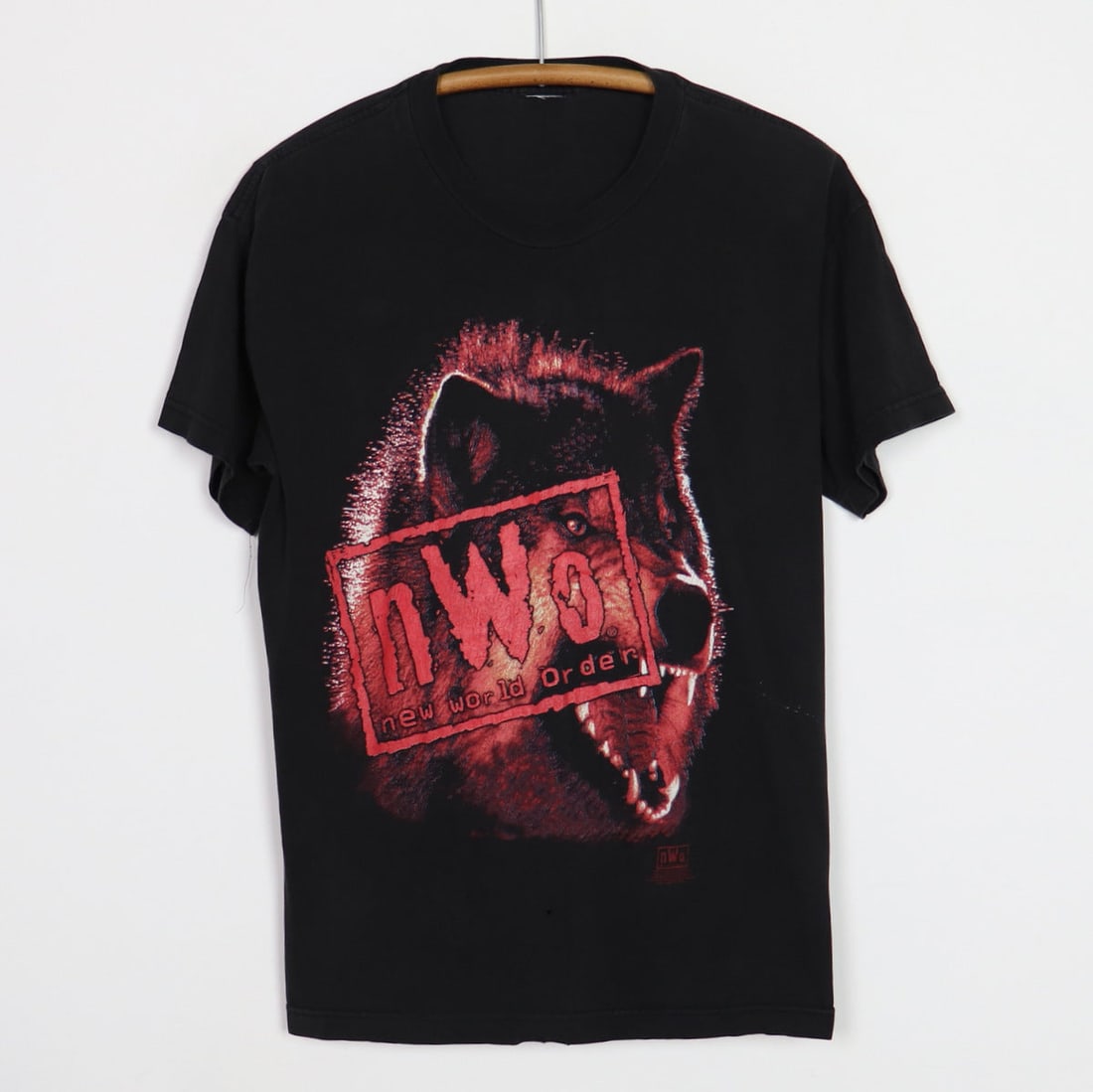Vintage 1998 WCW NWO Wolfpac Black Cotton Wrestling T-Shirt: Vintage 1998 WCW NWO Wolfpac Black Cotton Wrestling T-Shirt This is an original vintage 1998 NWO Wolfpac WCW shirt, not a modern reproduction. The shirt is black with no graphics on the back and is ma