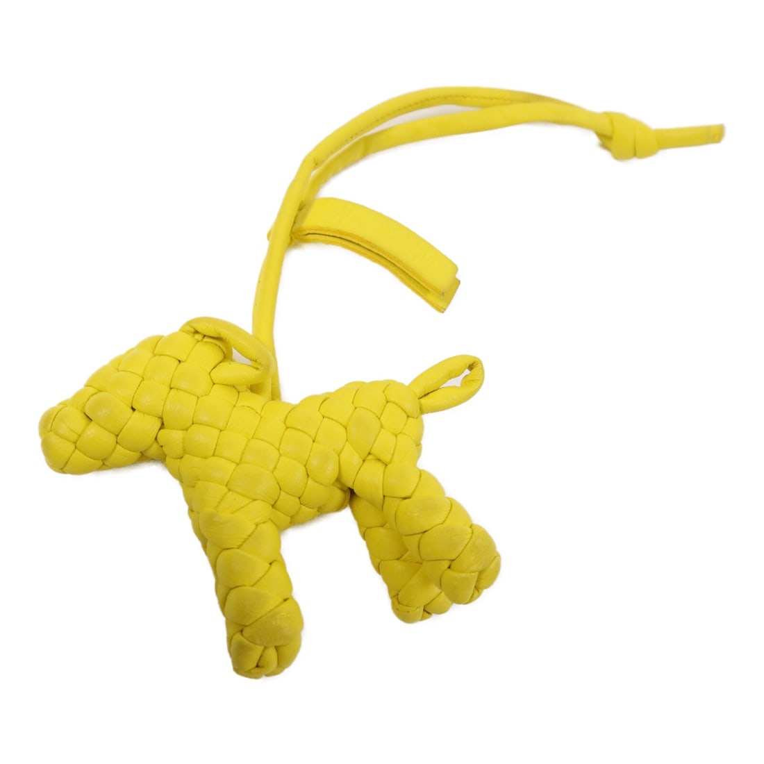 Yellow Calfskin Dog Bag Charm by Bottega Veneta: Yellow Calfskin Dog Bag Charm by Bottega Veneta This Bottega Veneta dog charm is crafted from yellow calfskin leather. Designed in Italy, it features a stylish and playful look, making it an ideal acc