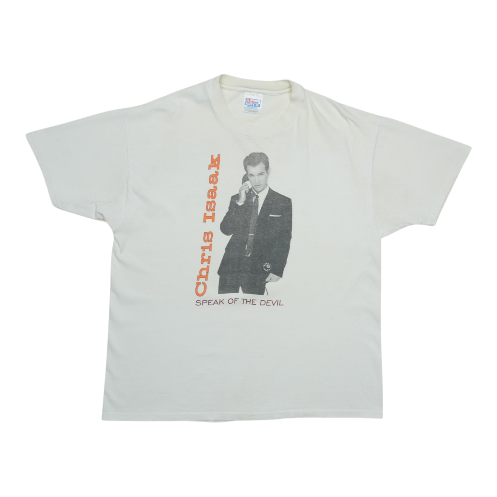 Vintage 1990s Chris Isaak Speak of the Devil White Cotton Graphic Tee: Vintage 1990s Chris Isaak Speak of the Devil White Cotton Graphic Tee This is an original vintage 1990s Chris Isaak 'Speak of the Devil' shirt, featuring both front and back graphics. It is not a mode