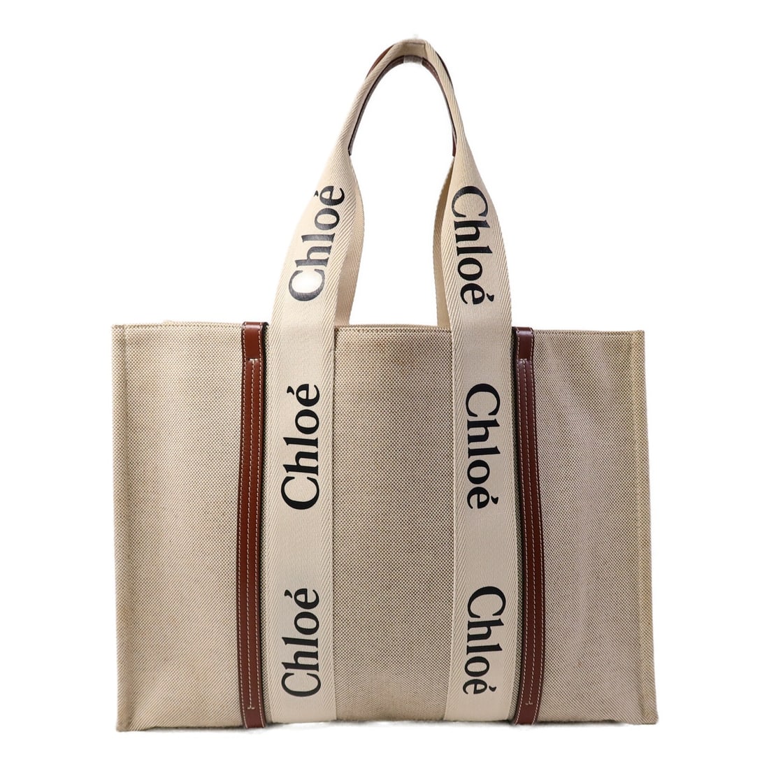 Chloe Woody Canvas Brown Large Women Tote Bag: Chloe Woody Canvas Brown Large Women Tote Bag This Chloe Woody Large Tote Bag is crafted from brown canvas and features a spacious design ideal for everyday use. The tote is designed for women and off