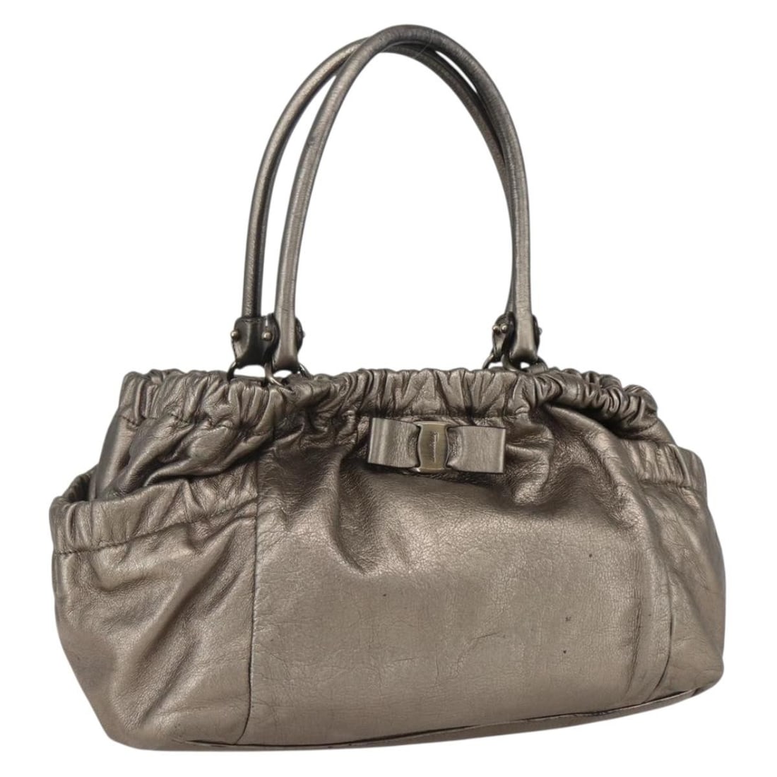 Leather Vala Handbag by Salvatore Ferragamo in Gold: Leather Vala Handbag by Salvatore Ferragamo in Gold This Salvatore Ferragamo Vala handbag for women features gold leather construction with metal fittings. It shows signs of wear including surface def