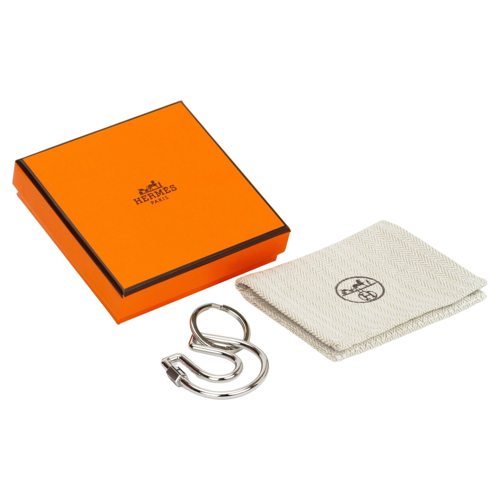 Hermes Fer a Cheval Palladium Horseshoe Shaped Key Ring: Hermes Fer a Cheval Palladium Horseshoe Shaped Key Ring This Hermes Fer a Cheval key ring is crafted in palladium silver and features a distinctive horseshoe shape with a subtle "H" signature. The ite