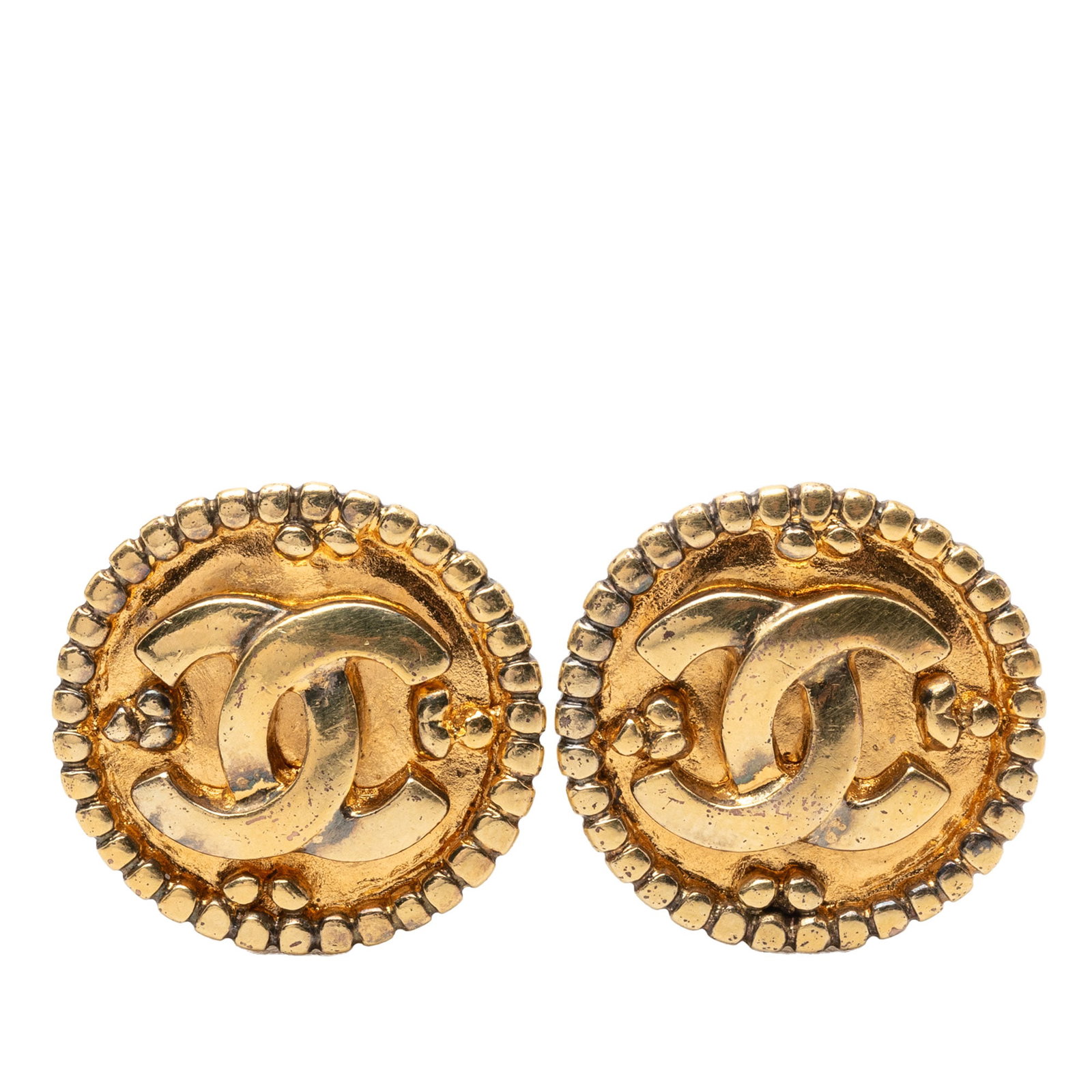 Chanel Gold Tone Metal CC Logo Clip On Round Earrings: Chanel Gold Tone Metal CC Logo Clip On Round Earrings These Chanel earrings feature a round design crafted from gold tone metal with clip-on closures. Made in Italy, they are classified as costume jew