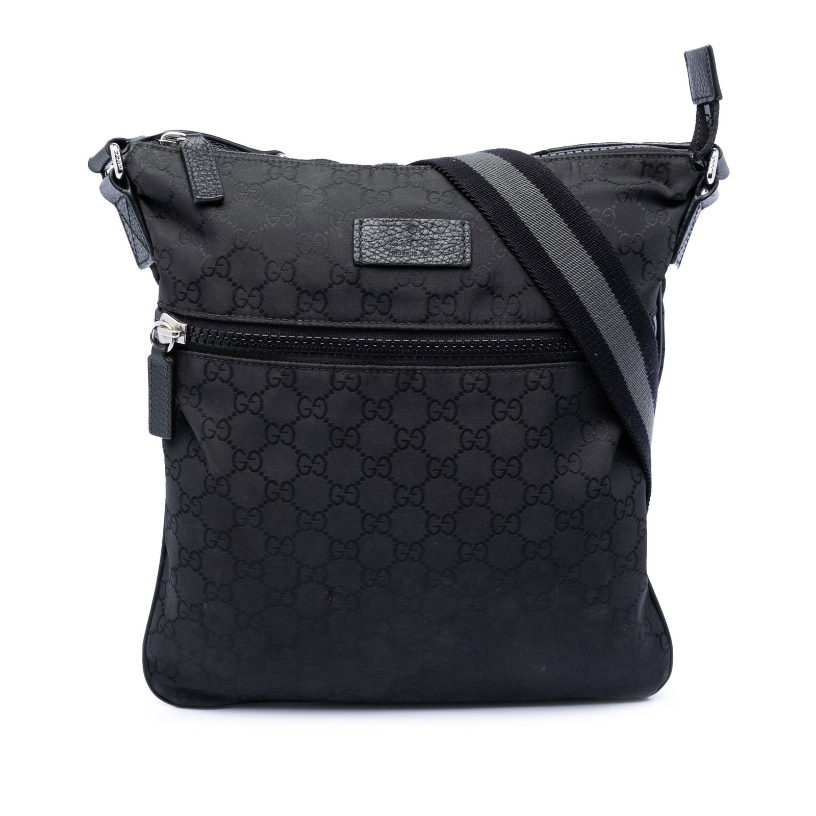 Black GG Nylon Adjustable Strap Crossbody Bag by Gucci: Black GG Nylon Adjustable Strap Crossbody Bag by Gucci This Gucci GG Nylon Crossbody bag features a durable nylon body in black with an adjustable flat strap for comfortable wear. It has a top zip clo
