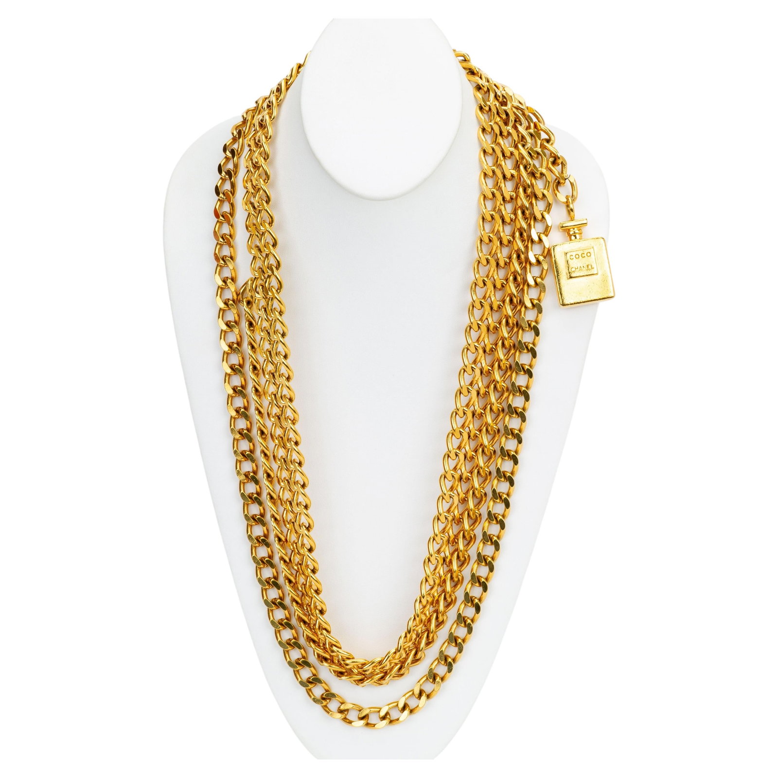 Chanel 1980s Gold Plated Chain Belt with Perfume Bottle Charm: Chanel 1980s Gold Plated Chain Belt with Perfume Bottle Charm This Chanel belt from the 1980s features multiple gold-plated chain layers and a signature perfume bottle charm, embodying the brand's ico