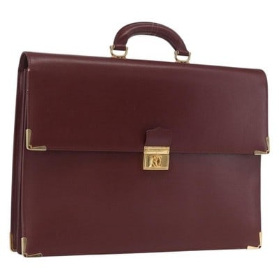 Cartier Must Line Leather Briefcase Bordeaux Gold Tone: Cartier Must Line Leather Briefcase Bordeaux Gold Tone This Cartier Must Line briefcase is crafted from Bordeaux leather with gold-tone accents. The bag features a structured silhouette with a top han