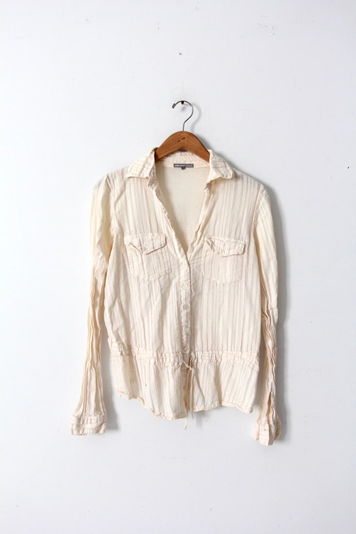 Vintage James Perse Cream Button-Down Blouse with Drawstring Waist: Vintage James Perse Cream Button-Down Blouse with Drawstring Waist This vintage James Perse cream blouse is designed with a button-down closure and a low neckline, complemented by a drawstring waist a