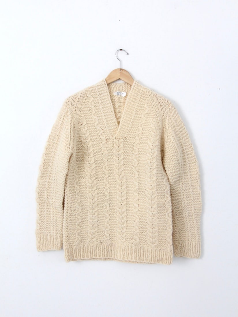 Cozy Vintage Greek All Wool Hand-Knit V-Neck Sweater: Cozy Vintage Greek All Wool Hand-Knit V-Neck Sweater Discover the timeless charm of this Vintage Greek Wool Sweater, a cozy piece crafted from all wool with a distinctive chunky cable knit pattern. Th