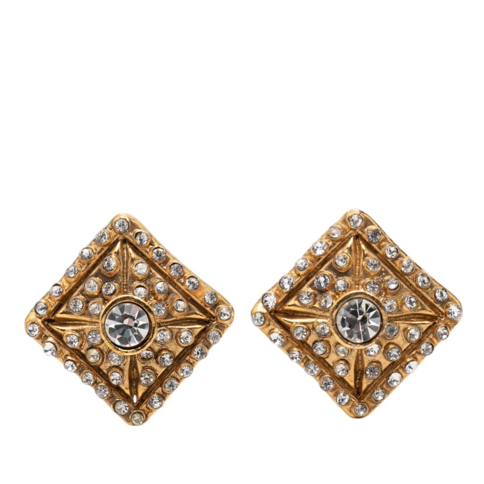 Chanel Strass Crystal Gold Tone Clip Earrings: Chanel Strass Crystal Gold Tone Clip Earrings These Chanel clip-on earrings feature gold-plated metal bodies adorned with crystal embellishments. Designed with back clip-on closures, they offer a clas
