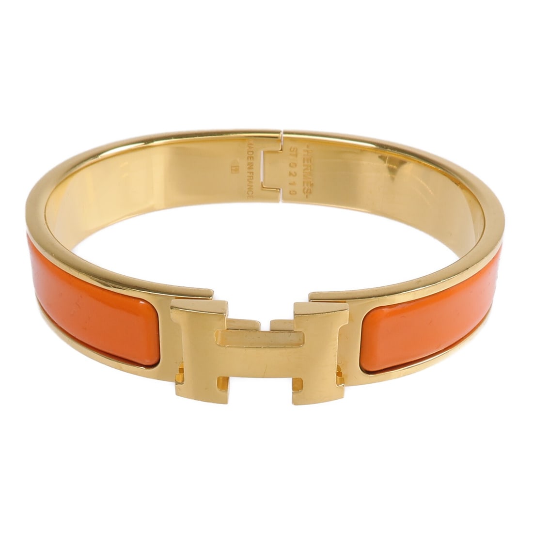 Hermes Clic H orange enamel bracelet: Hermes Clic H orange enamel bracelet This Hermes Clic-H bracelet features a vibrant orange enamel design with gold-tone accents. Crafted in France, it is designed for women and showcases the iconic st