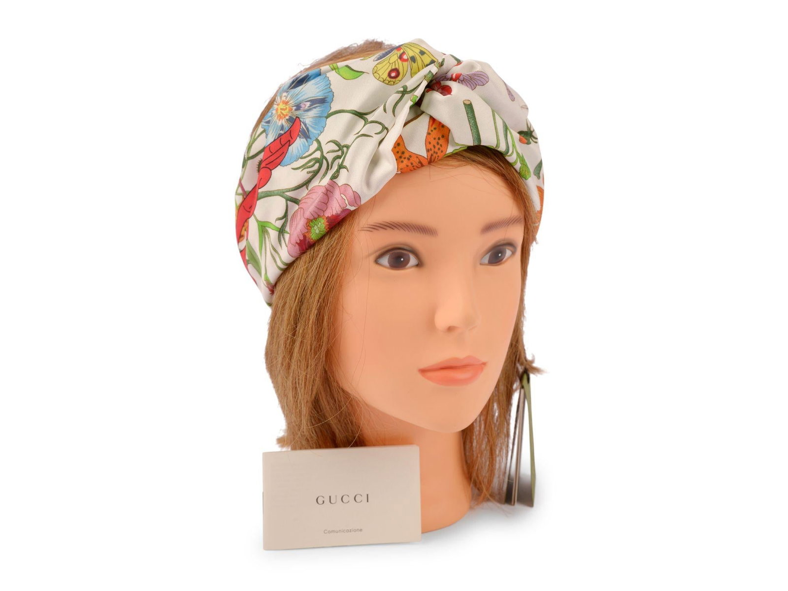 Flora Print Silk Headband by Gucci in White Medium: Flora Print Silk Headband by Gucci in White Medium This Gucci headband is crafted from 100% silk and features a white floral pattern print throughout. It is designed with a twisted detail at the front