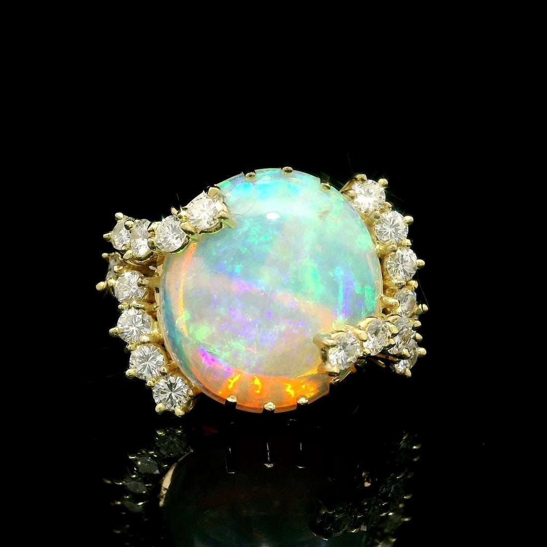 18k Yellow Gold 8.86ct Opal Cocktail Ring with Diamond Prongs: 18k Yellow Gold 8.86ct Opal Cocktail Ring with Diamond Prongs This exquisite cocktail ring showcases a stunning natural fiery opal, elegantly set in solid 18k yellow gold. The opal features a roundish
