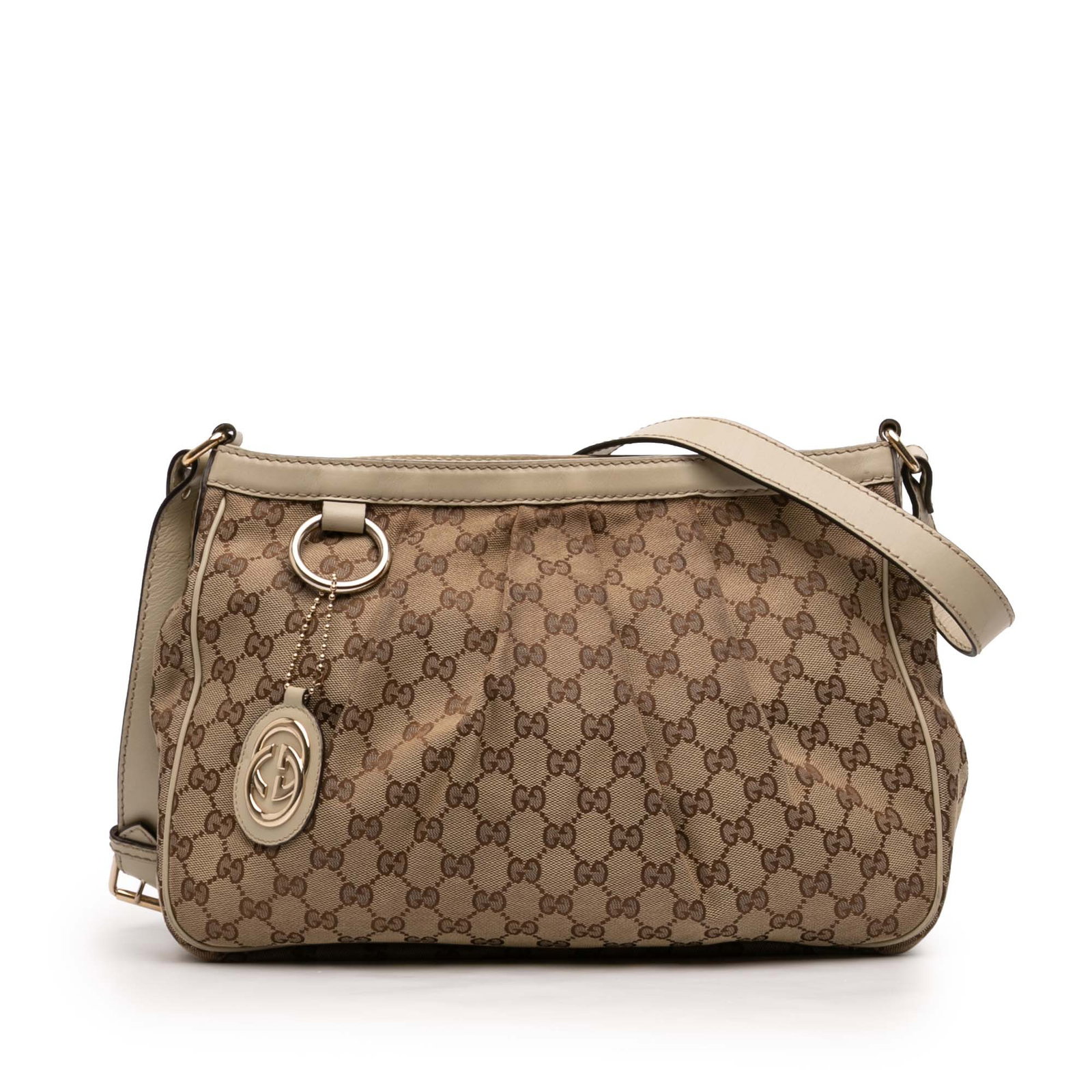 Gucci Sukey Beige Canvas and Leather Adjustable Crossbody Bag: Gucci Sukey Beige Canvas and Leather Adjustable Crossbody Bag The Gucci GG Canvas Sukey Crossbody showcases a beige canvas body with leather trim, an adjustable flat leather strap, and a top zip closu