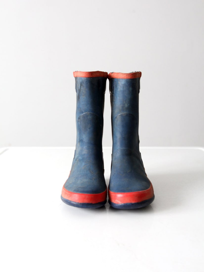 Vintage Kid's Rubber Boots Blue Red Trim Honor's Brand: Vintage Kid's Rubber Boots Blue Red Trim Honor's Brand Step into vintage charm with this pair of kid's rubber boots. These blue boots are accentuated with vibrant red trim and lining, showcasing the H