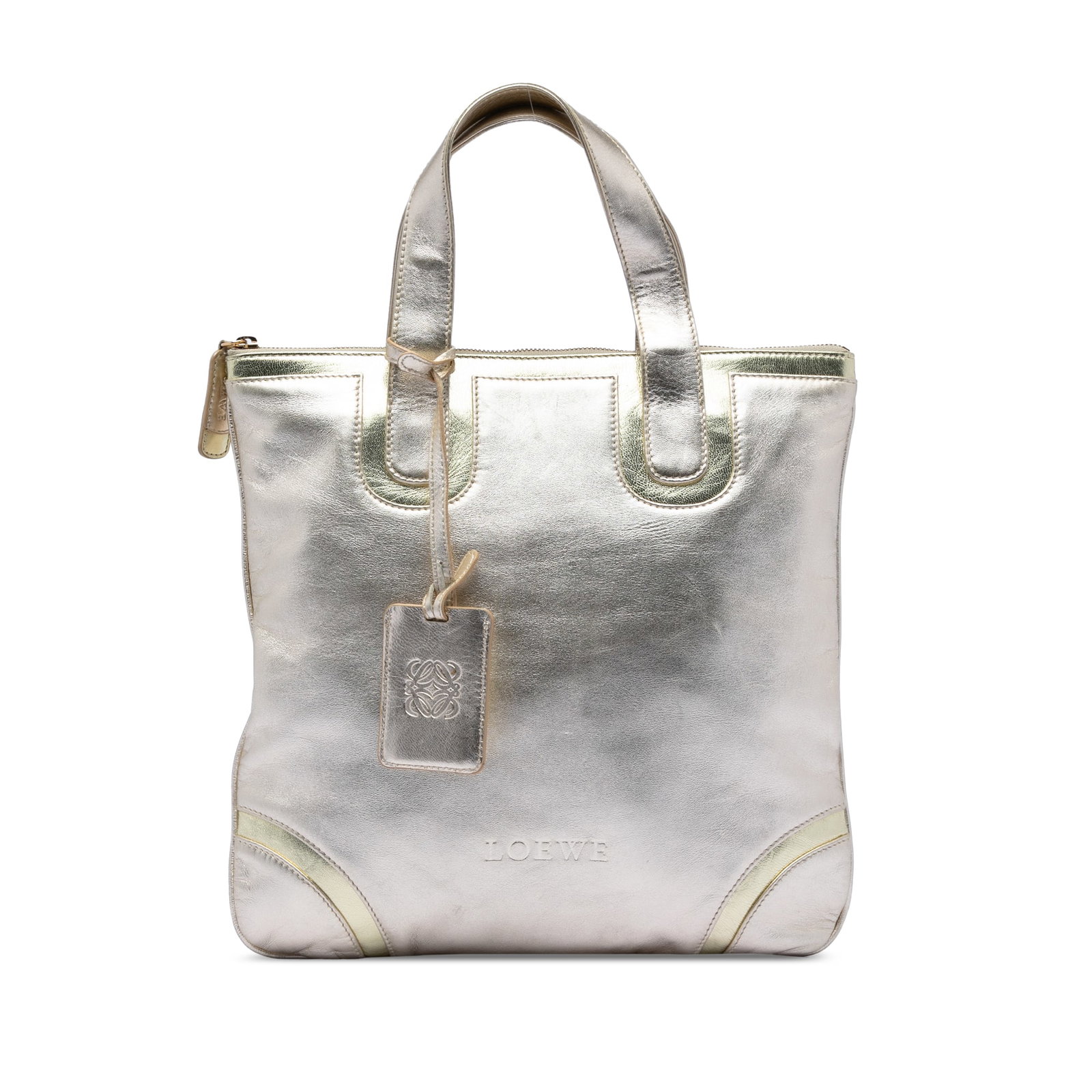 Metallic Silver Leather Tote Bag by Loewe with Top Zip Closure: Metallic Silver Leather Tote Bag by Loewe with Top Zip Closure This LOEWE Metallic Leather Tote features a silver metallic leather body with flat leather handles, a top zip closure, and an interior zi