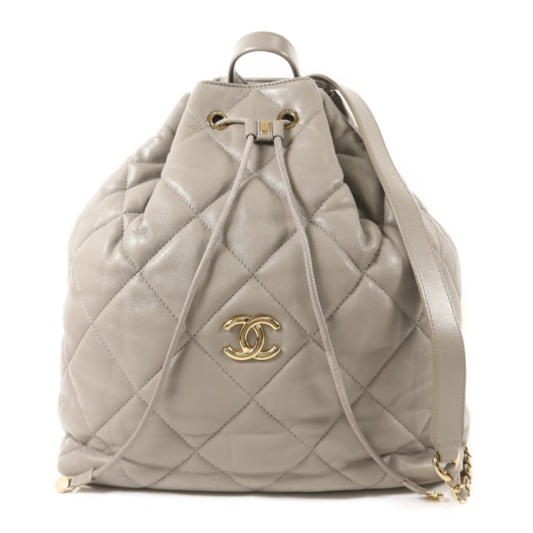Chanel Gray Lambskin Backpack with CC Logo and Gold Hardware: Chanel Gray Lambskin Backpack with CC Logo and Gold Hardware This CHANEL CC backpack features luxurious gray lambskin leather and gold-tone hardware. Designed in a classic rucksack style, it offers a 