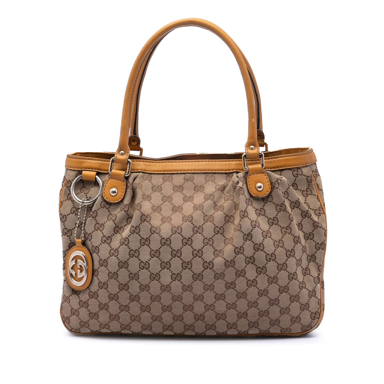 Gucci Sukey Tote Bag in GG Canvas with Leather Trim: Gucci Sukey Tote Bag in GG Canvas with Leather Trim This Gucci GG Canvas Sukey Tote features a beige canvas body with leather trim, rolled leather handles, an open top with magnetic snap closure, an i